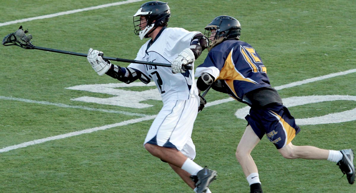 Tyler Sweeney-Marquez cradles the ball past a defender during the 2013 season