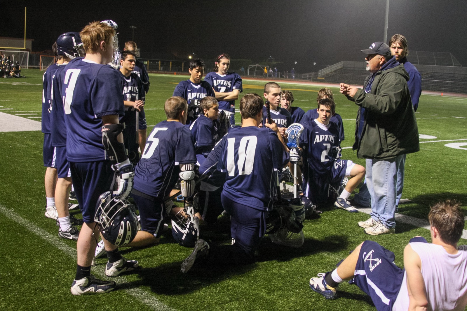Coach Paul Murtha addresses the Aptos Mariners during a night game at Watsonville