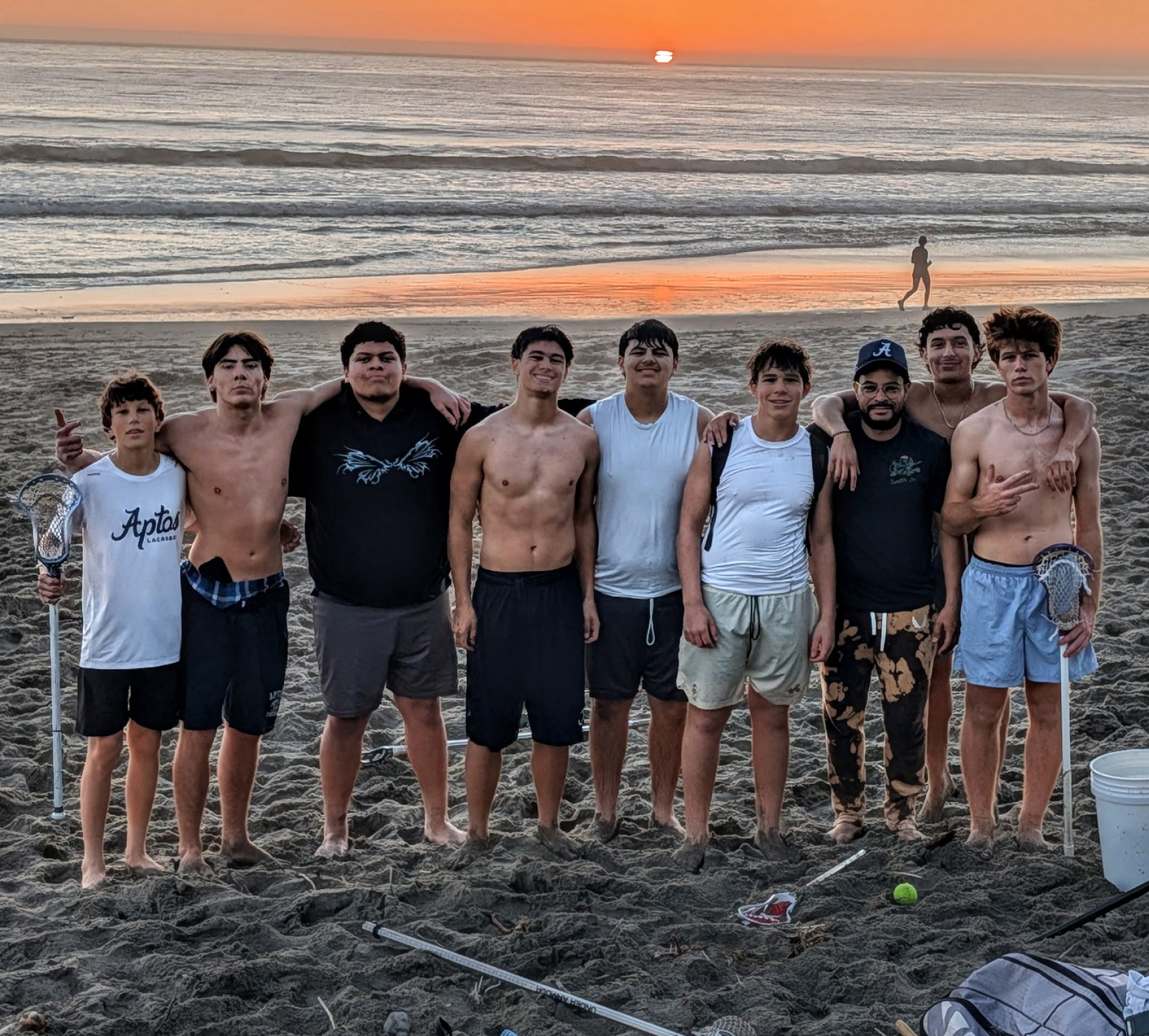 Aptos Mariners lacrosse players practice on the sand at Platforms Beach in Aptos