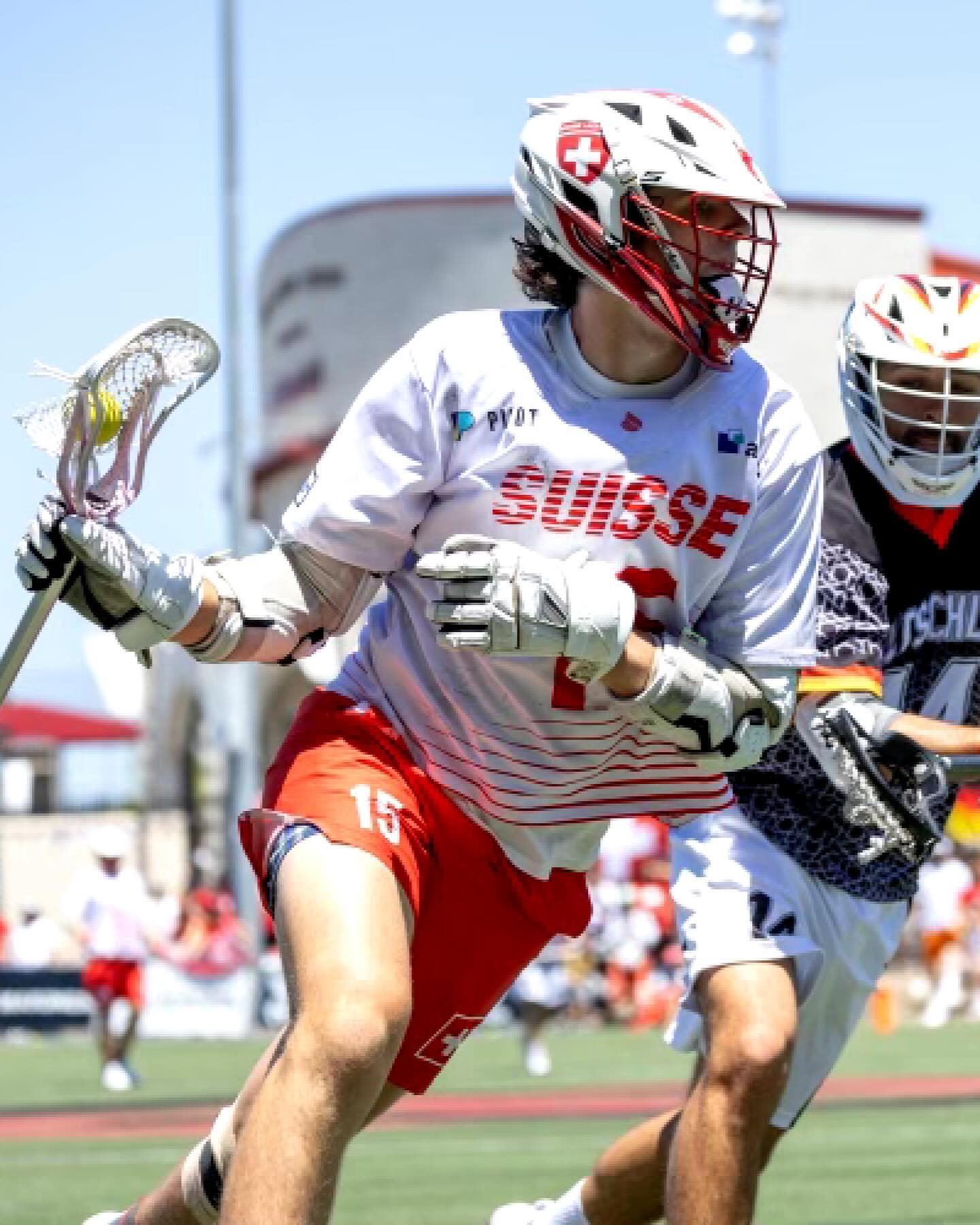Aidan Niklaus #15 in Suisse kit driving past a German defender