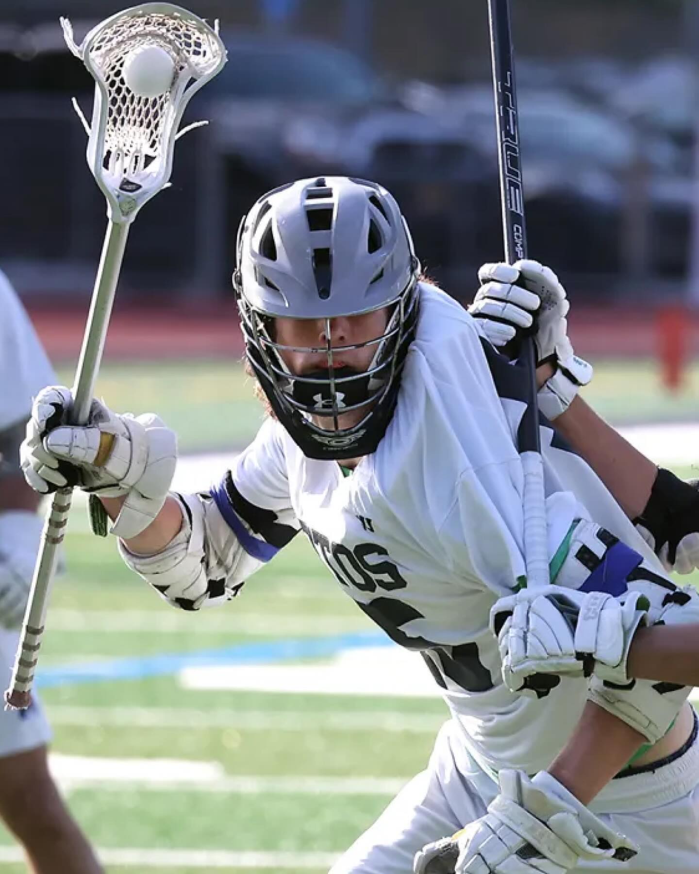 Aidan Niklaus in Aptos Mariners white cradling the ball